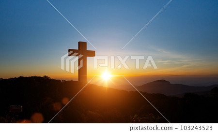 Silhouettes of Christian cross symbol on top mountain at sunrise sky background. 103243523