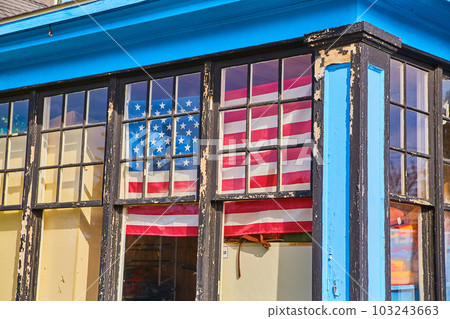 Chipped black paint windows with blue house and American red white and blue flag Chipped black paint windows with blue house and American red white and blue flag 103243663