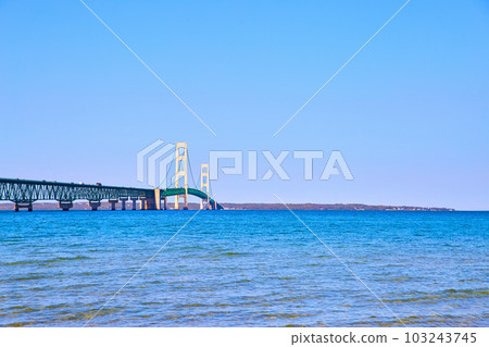 Mackinac Bridge with distant shore and Lake Michigan and Lake Huron Mackinac Bridge with distant shore and Lake Michigan and Lake Huron 103243745