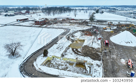 Debris poking out of the snow at construction site aerial drone shot Debris poking out of the snow at construction site aerial drone shot 103243950