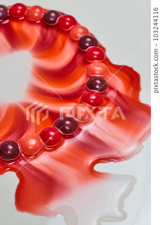 Abstract comet of colors with abstract background asset creating a red blood pink passion and purple blitz of color on white plate 103244116
