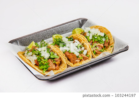 Three cow tongue street tacos on white background asset 103244197