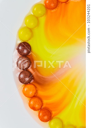 Halloween candy in water seeps to off center middle on white background 103244201