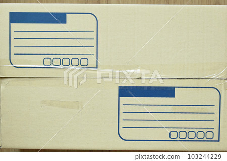 brown post box packaging put on wood floor 103244229