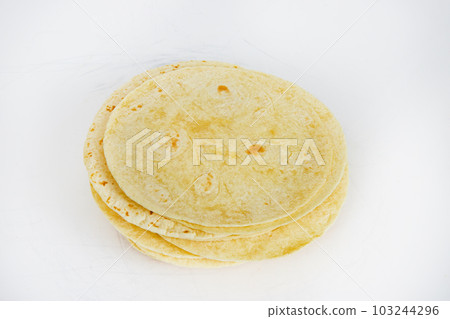 Top down view of a stack of 20 flour tortillas pre grilled on white background Top down view of a stack of 20 flour tortillas pre grilled on white background 103244296