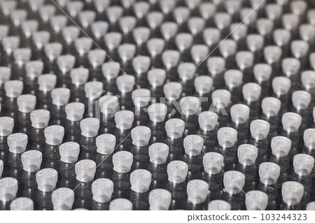 Wall of tiny machine parts to probe in metrology CMM machine for small flaws asset background 103244323