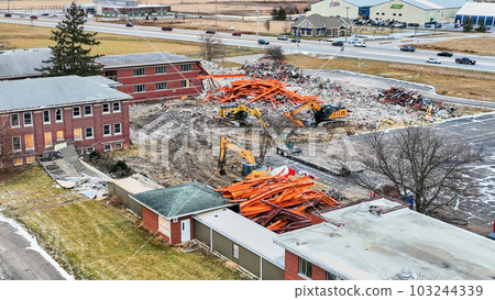 Drone aerial of construction zone as abandoned hospital is deconstructed 103244339