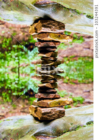 Hemlock cliffs with abstract and artistic rock pile path marker statue Hemlock cliffs with abstract and artistic rock pile path marker statue 103244391