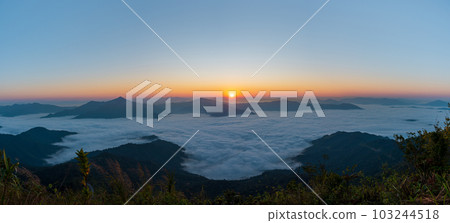 Beautiful landscape on the mountains at sunrise. Spectacular view in foggy valley 103244518