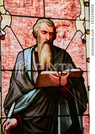 Mathew, Mark, John, or Luke apostle saint holding Christian bible book and quill church window 103244608