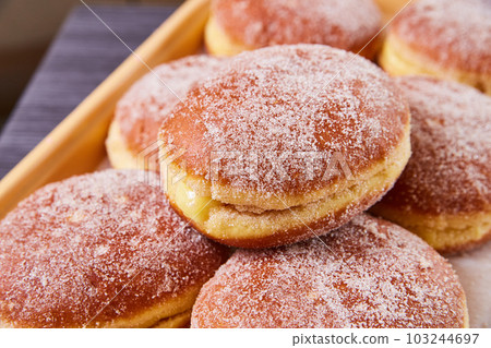 Mexican baked goods pastry donut red jelly strawberry filled oozing outside in pile of sugary sweets Mexican baked goods pastry donut red jelly strawberry filled oozing outside in pile of sugary sweets 103244697