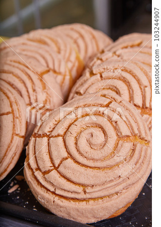 Mexican sweet bread conchas chocolate cocoa on black tray baked goods Mexican sweet bread conchas chocolate cocoa on black tray baked goods 103244907