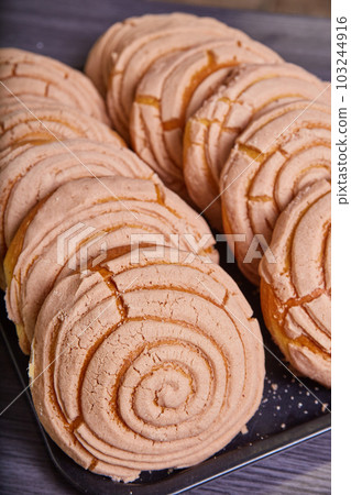 Cinnamon bread conchas Mexican sweet bread baked goods on tray 103244916