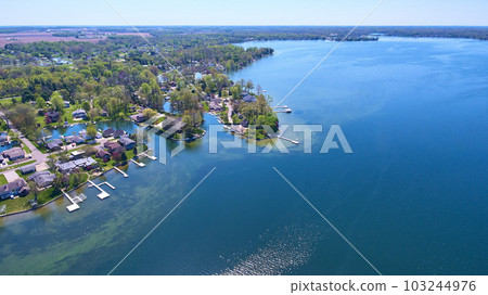 Lake houses on distant shore aerial asset water property green algae in water piers and docks Lake houses on distant shore aerial asset water property green algae in water piers and docks 103244976