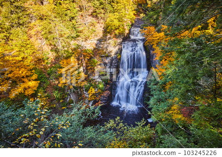Large waterfall from above surrounded by colorful forests Large waterfall from above surrounded by colorful forests 103245226