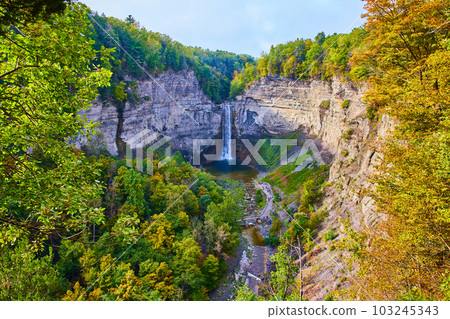 Fall forests around giant rocky canyon and large waterfall Fall forests around giant rocky canyon and large waterfall 103245343