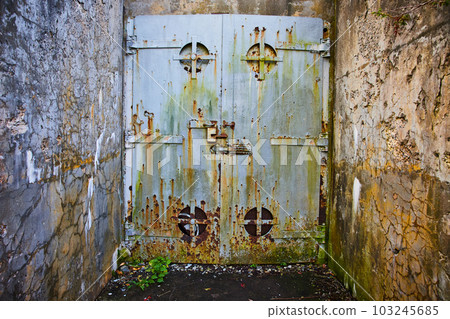 Old mine entrance with cement walls and huge steel door rusting Old mine entrance with cement walls and huge steel door rusting 103245685