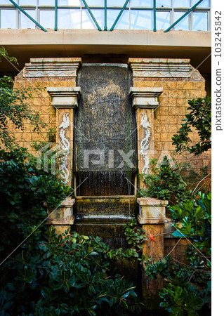 Temple display in bird exhibit with forest and manmade waterfall 103245842