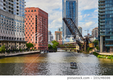 Raised bridge in canals of Chicago with ships and skyscrapers 103246086