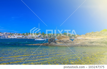 Sailing boats and Cadaques village beach, Catalonia, Costa Brava, Spain 103247375