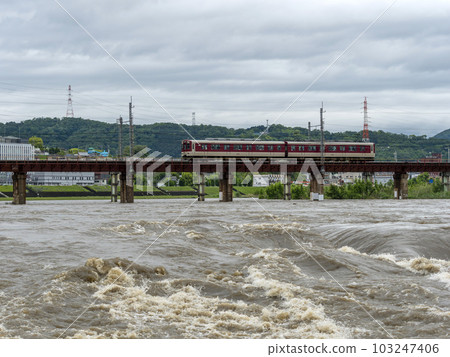 A train crossing a river swollen by heavy rain A train crossing a river swollen by heavy rain 103247406