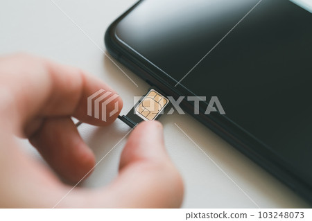 Insert sim card into smartphone Insert sim card into smartphone 103248073