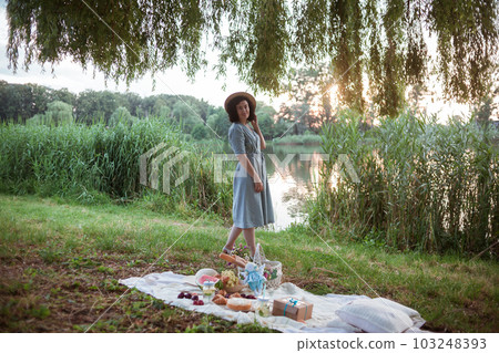 A young woman going on a picnic in a park 103248393