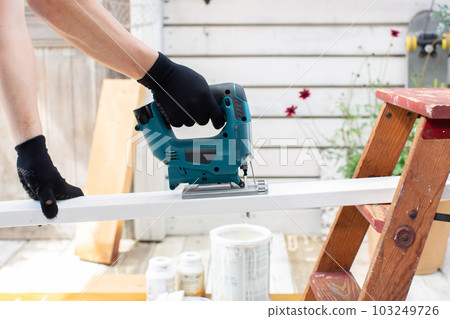 A man who works hard on DIY on the veranda A man who works hard on DIY on the veranda 103249726