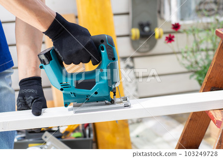 A man who works hard on DIY on the veranda 103249728