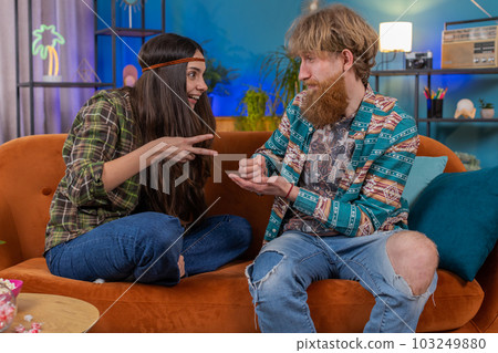 Family marriage hippie couple man woman laughing playing to Rock Paper Scissors gambling hands game 103249880