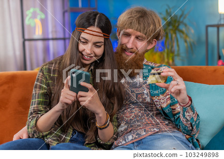 Family man woman using credit bank card and smartphone, transferring money purchases online shopping Family man woman using credit bank card and smartphone, transferring money purchases online shopping 103249898