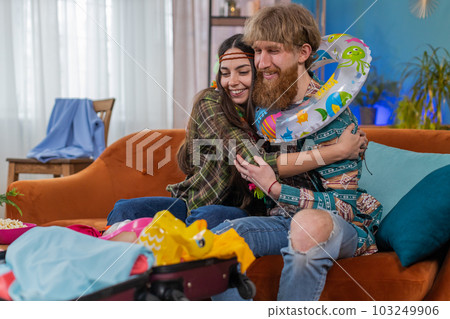 Happy family man woman tourist packing suitcase luggage preparation for vacation trip journey at sea Happy family man woman tourist packing suitcase luggage preparation for vacation trip journey at sea 103249906