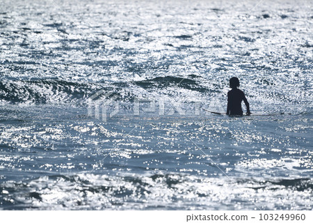 Glowing ocean and surfer silhouette 103249960