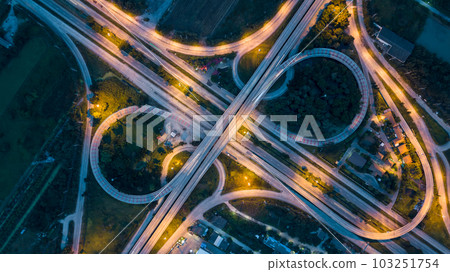 Aerial top view of highway and overpass in city at night, Aerial view of the traffic and intersection road at the city, Highway road junctions at night. 103251754