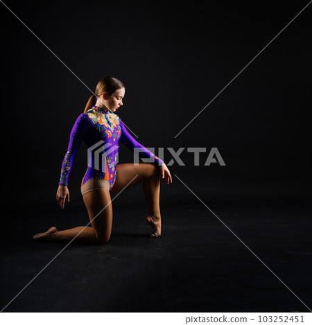 Beautiful cool young fit gymnast woman in sportswear dress working out, performing art gymnastics Beautiful cool young fit gymnast woman in sportswear dress working out, performing art gymnastics 103252451
