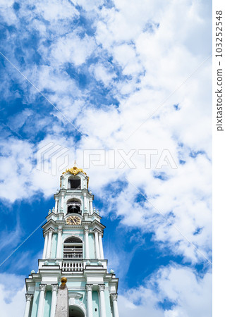 bell tower of cathedral under clouds in blue sky 103252548