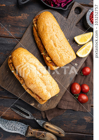 Tantuni doner kebab Somun ekmek tavuk, on old dark  wooden table background, top view flat lay 103252757