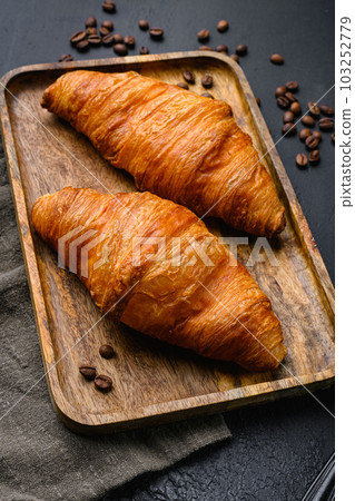 Warm butter creamy baked croissants set, on black dark stone table background 103252779