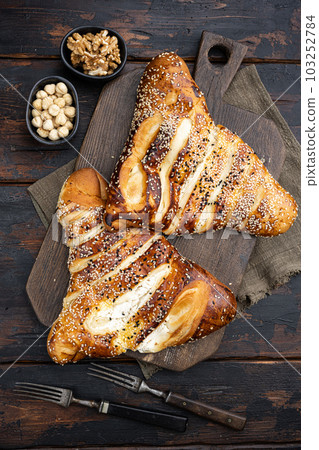 Turkish pastry filled with cheese, on old dark wooden table background, top view flat lay Turkish pastry filled with cheese, on old dark wooden table background, top view flat lay 103252784