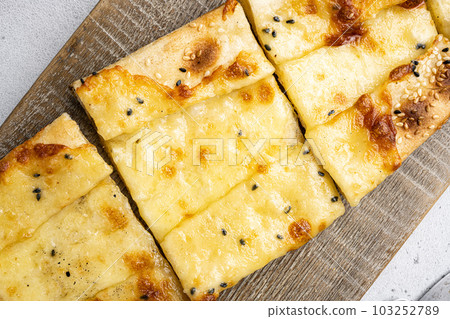 Turkish Cuisine baked dish pide, on gray concrete table background, close up macro, top view flat lay 103252789