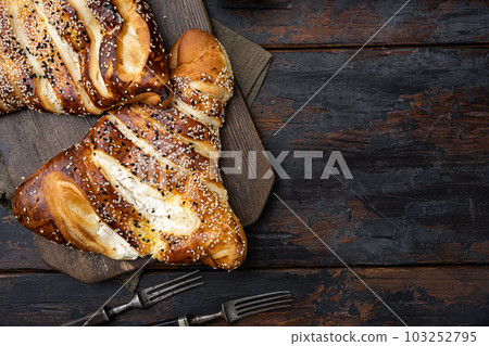 Burekas triangle filled with cheese painir , on old dark wooden table background, top view flat lay, with copy space for text Burekas triangle filled with cheese painir , on old dark wooden table background, top view flat lay, with copy space for text 103252795