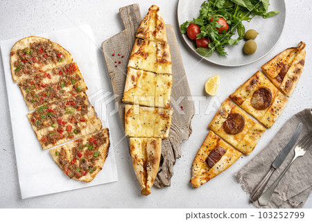 Assorted Kasarli Kiymali sucuklu  pide Turkish dish, on gray concrete table background, on gray concrete table background, top view flat lay 103252799