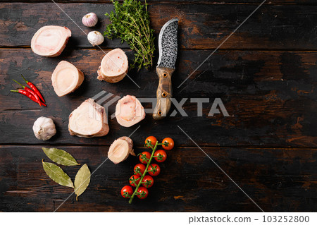 Raw beef marrow bones, on old dark wooden table background, top view flat lay, with copy space for text Raw beef marrow bones, on old dark wooden table background, top view flat lay, with copy space for text 103252800