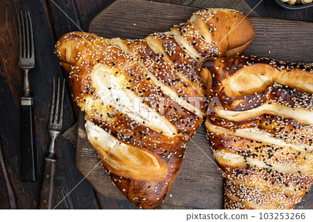 Baked Pastry triangle With Savory Filling Of Cheese, on old dark  wooden table background, top view flat lay 103253266