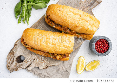 Somun ekmek tavuk tantuni Chicken Turkish kebab, on gray concrete table background, top view flat lay Somun ekmek tavuk tantuni Chicken Turkish kebab, on gray concrete table background, top view flat lay 103253278