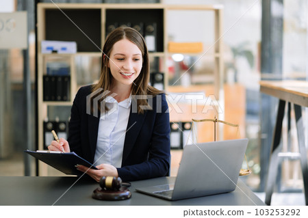 Beautiful woman lawyer working and gavel, tablet and laptop in front, Advice justice and law concept 103253292