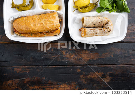 Somun ekmek tavuk tantuni Chicken Turkish doner kebab durum, on old dark wooden table background, top view flat lay, with copy space for text Somun ekmek tavuk tantuni Chicken Turkish doner kebab durum, on old dark wooden table background, top view flat lay, with copy space for text 103253514
