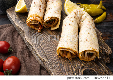 Traditional Turkish cuisine doner kebab, on old dark  wooden table background 103253515