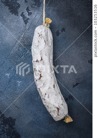 Whole spanish salchichon wurst on blue background Whole spanish salchichon wurst on blue background 103253516