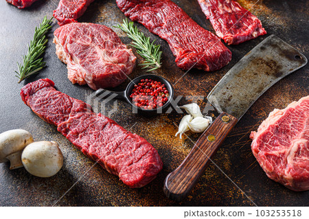 Side view Close up machete Steak, Flank steak, cut near denver alternative beef steak and a cleaver butcher meat knife   a rustic metall background 103253518